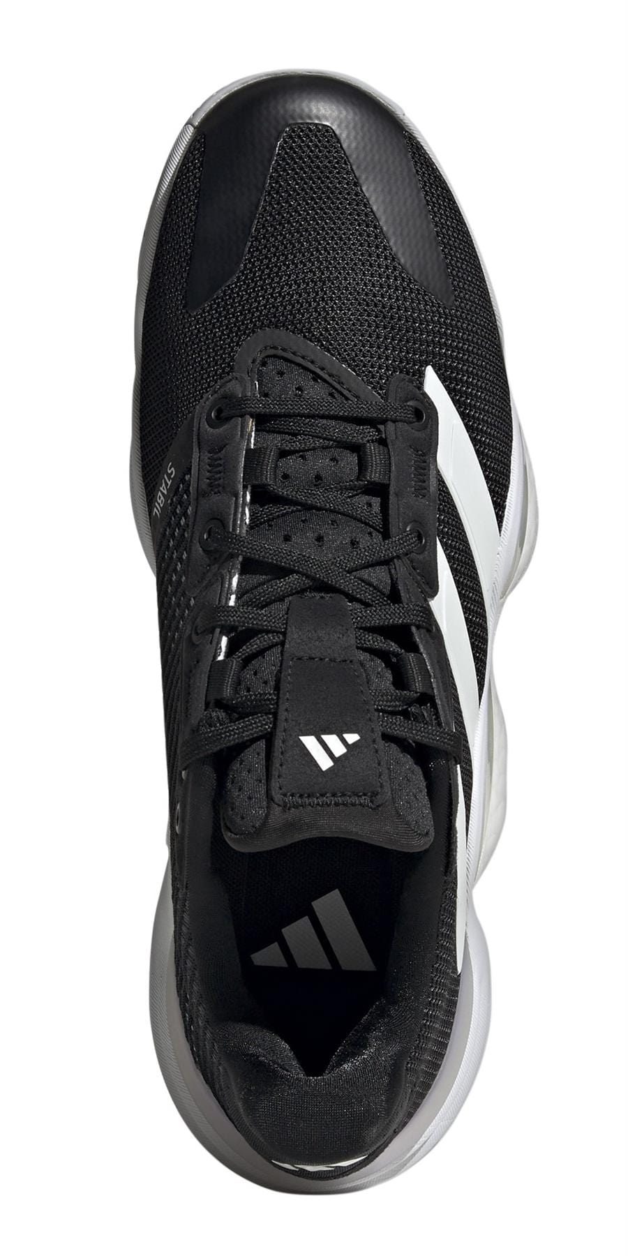 The ADIDAS Stabil 16 Men's Indoor Court Shoes feature a mesh texture in black with white accents, black laces, a logo on the tongue, and an adidas BOOST midsole for comfort. The brand logo is near the heel on the sleek white sole.