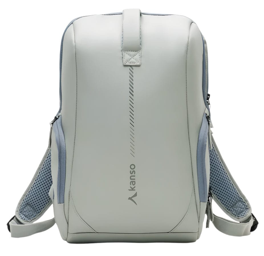 The Kanso Intuko Tennis 23L Backpack in gray is a sleek, minimalist accessory featuring blue mesh side pockets, padded shoulder straps, and a discreet racket compartment. It has reflective print, a vertical design element, and the brand name "Kanso," embodying modern style.