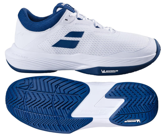 A pair of Babolat SFX 4 All Court 2025 Men's Tennis Shoes in white and estate blue. The upper shoe displays a side view with branding, while the lower reveals the textured sole pattern for comfort. Logo details are visible on both the shoe and sole.