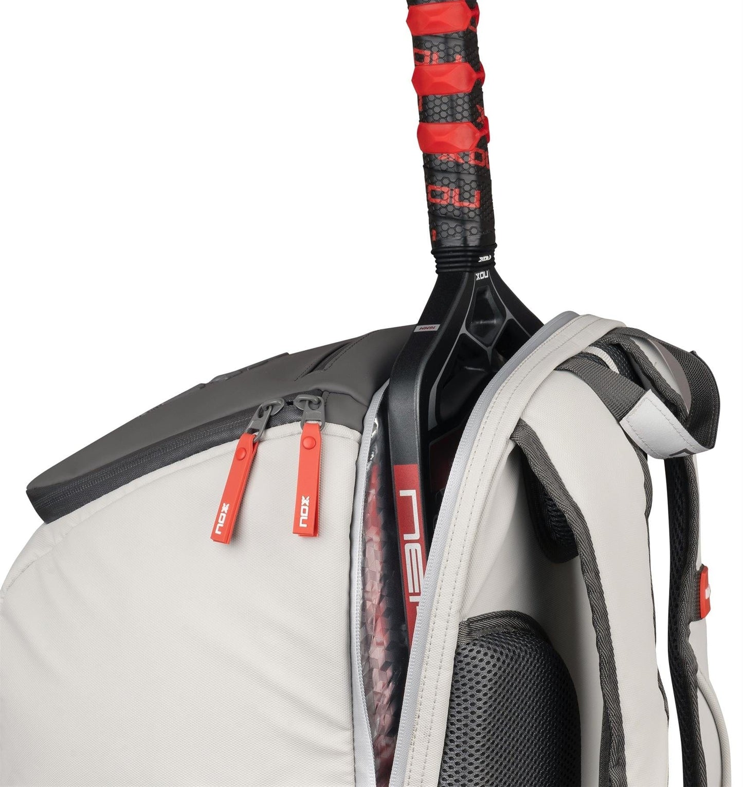 A close-up of the NOX Supra Pickleball Backpack - Cream by NOX, with black accents and red zipper pulls, ergonomic padded straps, and a tennis racquet with a red grip partially tucked into the side compartment.