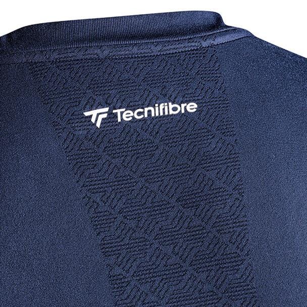 Close-up of the Tecnifibre Men's Tennis Seamless Baselayer in Marine, featuring a subtle geometric pattern. The word "Tecnifibre" is in white near the collar on the back, making this garment ideal for wicking perspiration during cold weather sports activities.