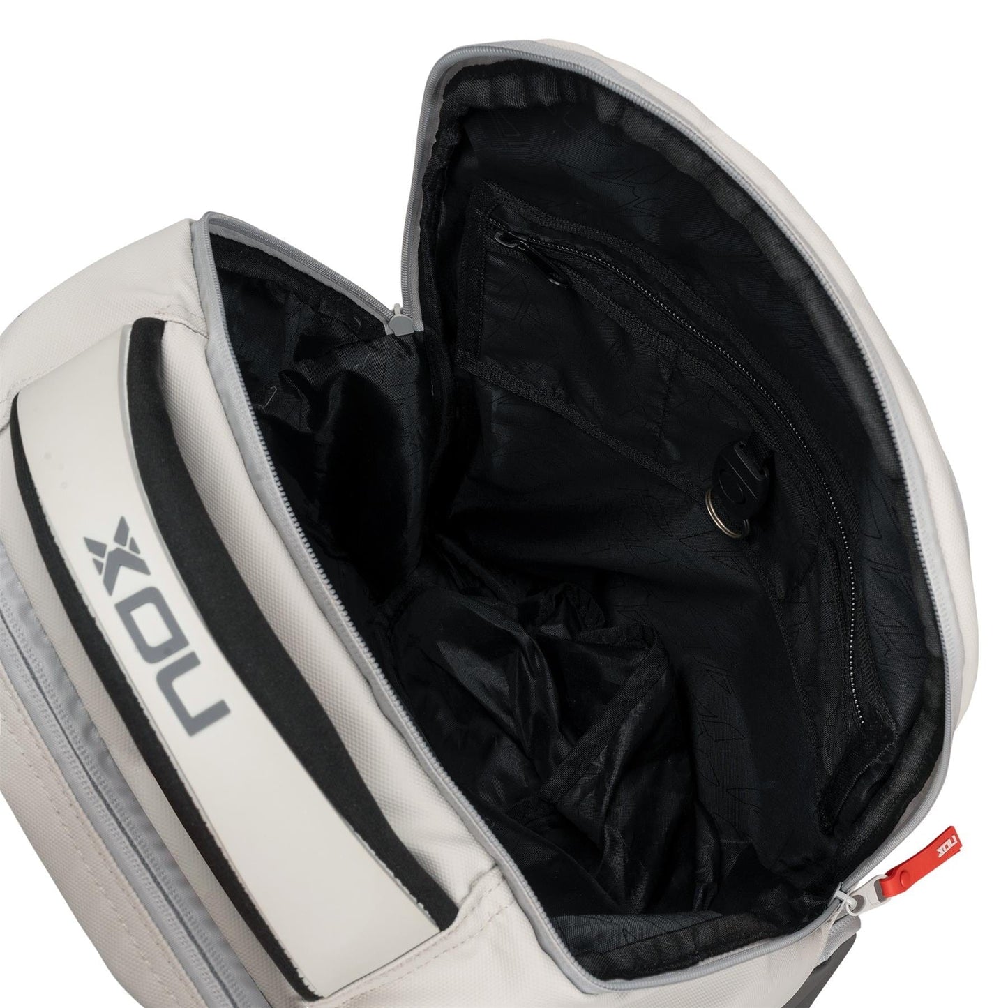 The NOX Pro Pickleball Backpack - Cream by NOX features a spacious black interior with a zippered pocket, key holder clasp, and ergonomic padded straps. The partially unzipped bag reveals its sleek inside lining for easy access and organized carrying.