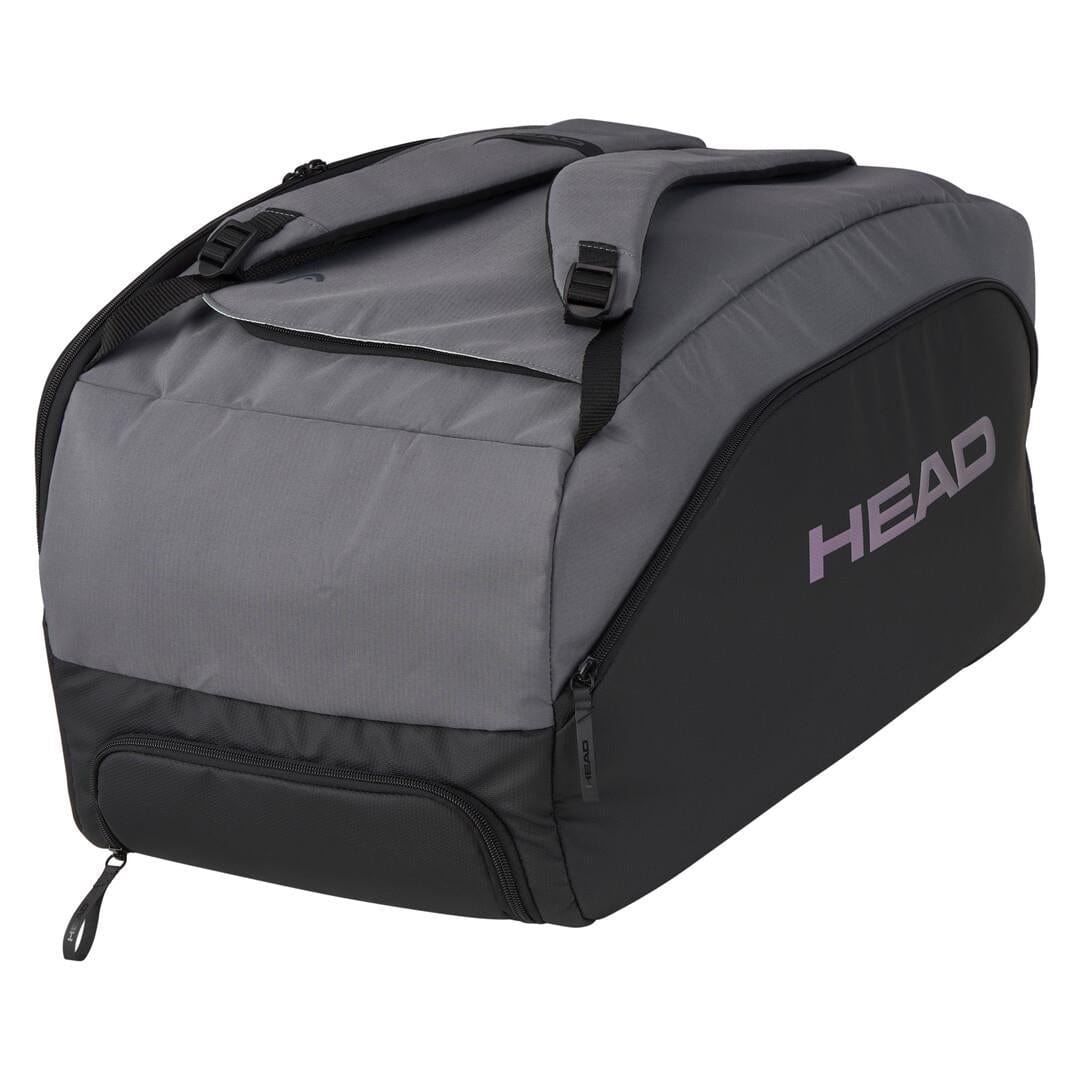 The HEAD Pro X Tennis Duffle Bag - Black/Dark Grey by HEAD features "HEAD" printed in purple, crafted from recycled PET bottles. It includes shoulder straps, multiple zippered compartments, and a shoe compartment, making it a sustainable choice for an active lifestyle.