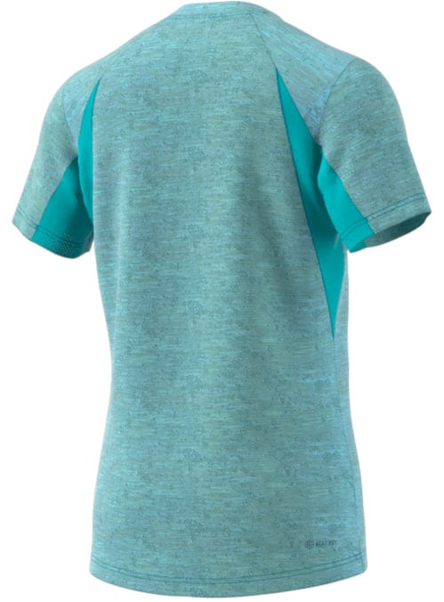 Seen from the back, the ADIDAS Men's Freelift Tennis T-Shirt in a heathered blue showcases darker blue panels and incorporates AEROREADY technology to help keep you cool during intense tennis matches.