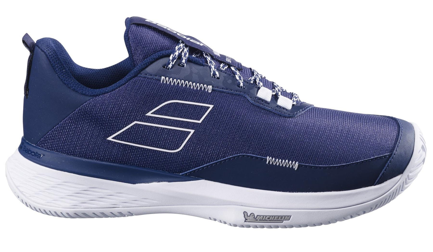 The Babolat SFX EVO All Court 2025 Men's Tennis Shoes in dark blue/white feature a sleek design with white laces and sole. Two geometric stripes adorn the side, while the "Michelin Original rubber" logo on the sole ensures a durable tread for grip on any court surface.