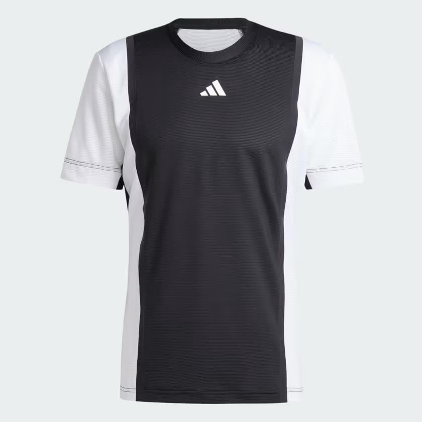 The adidas Mens Pro Freelift 3D Tennis T-Shirt - Black / White is a short-sleeve sports jersey featuring a small Adidas logo on the front. It is designed with Freelift 3D sleeves and equipped with HEAT.RDY technology for enhanced performance, showcasing a black central panel complemented by white sides and sleeves.