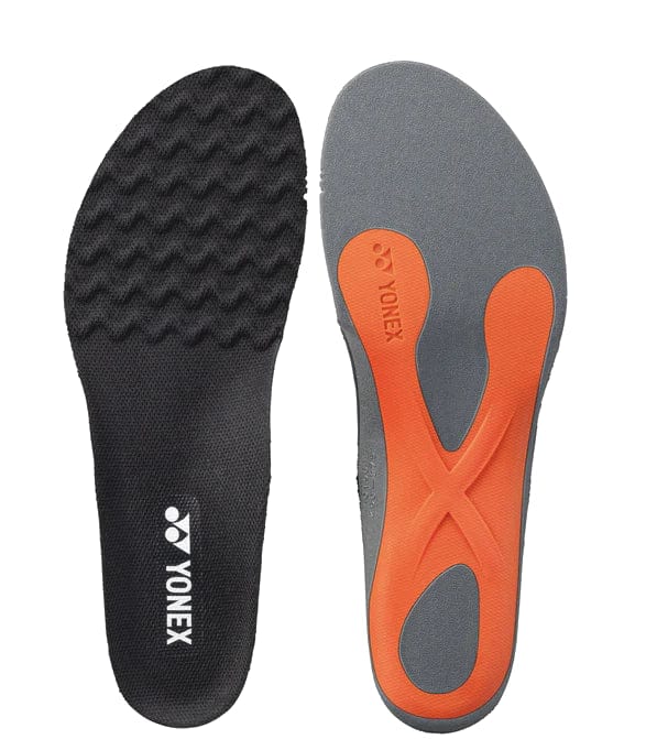 Introducing the Yonex AC196 Power Cushion Agility Insole, featuring advanced Power Cushion technology. The left insole is designed in black with a unique wavy texture and proudly displays the Yonex logo, while the right insole comes in grey with striking orange accents and a distinctive cross pattern. Enhanced for agility, these insoles are engineered to boost performance and prominently feature the signature Yonex logo near the heel.
