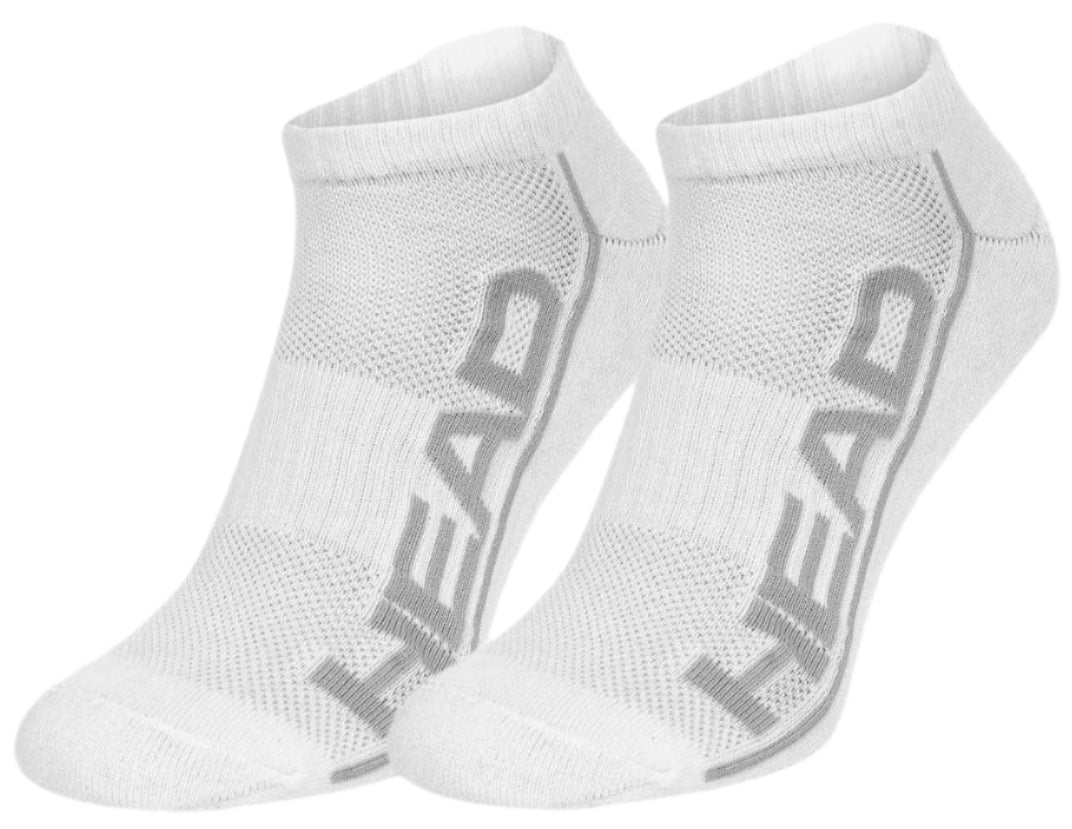 The HEAD Performance Sneaker Socks (2 Pack) in white showcase the brand name "HEAD" prominently in large gray lettering along the sides against a white background. Engineered for performance, these ankle socks are crafted with a ribbed texture and reinforced toe area to maximize air circulation and provide enhanced shock absorption.