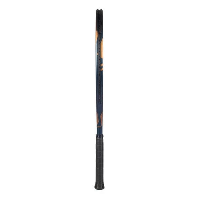 The side profile of a Prince Warrior 100 2023 265g tennis racket showcases its elegant black handle and a blue graphite frame. The strings and branded details are discreetly obscured from view, preserving an aura of mystery.