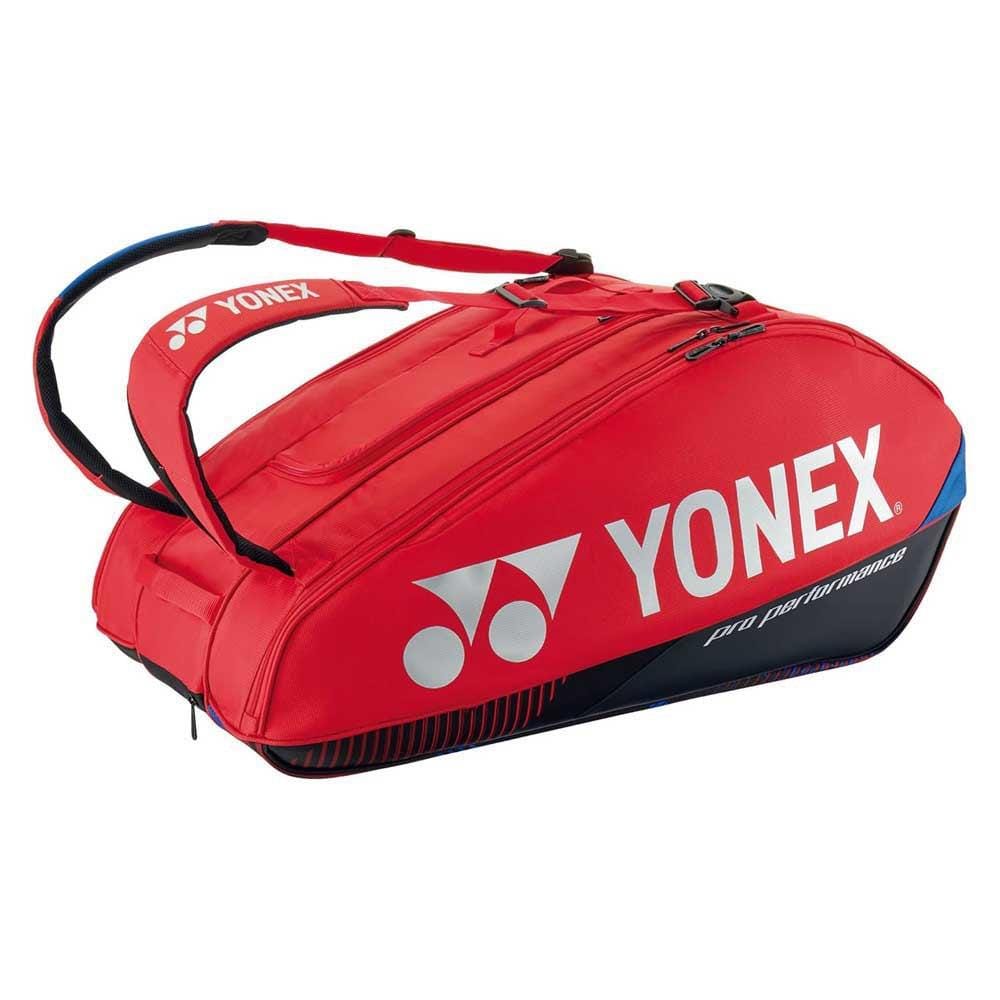 The Yonex 92429EX 9 Racket Pro Tennis Bag in Scarlet features the iconic brand logo and "Pro Performance" printed on it. This bag includes Thermo Guard lining, multiple compartments, and padded shoulder straps for comfortable carrying.
