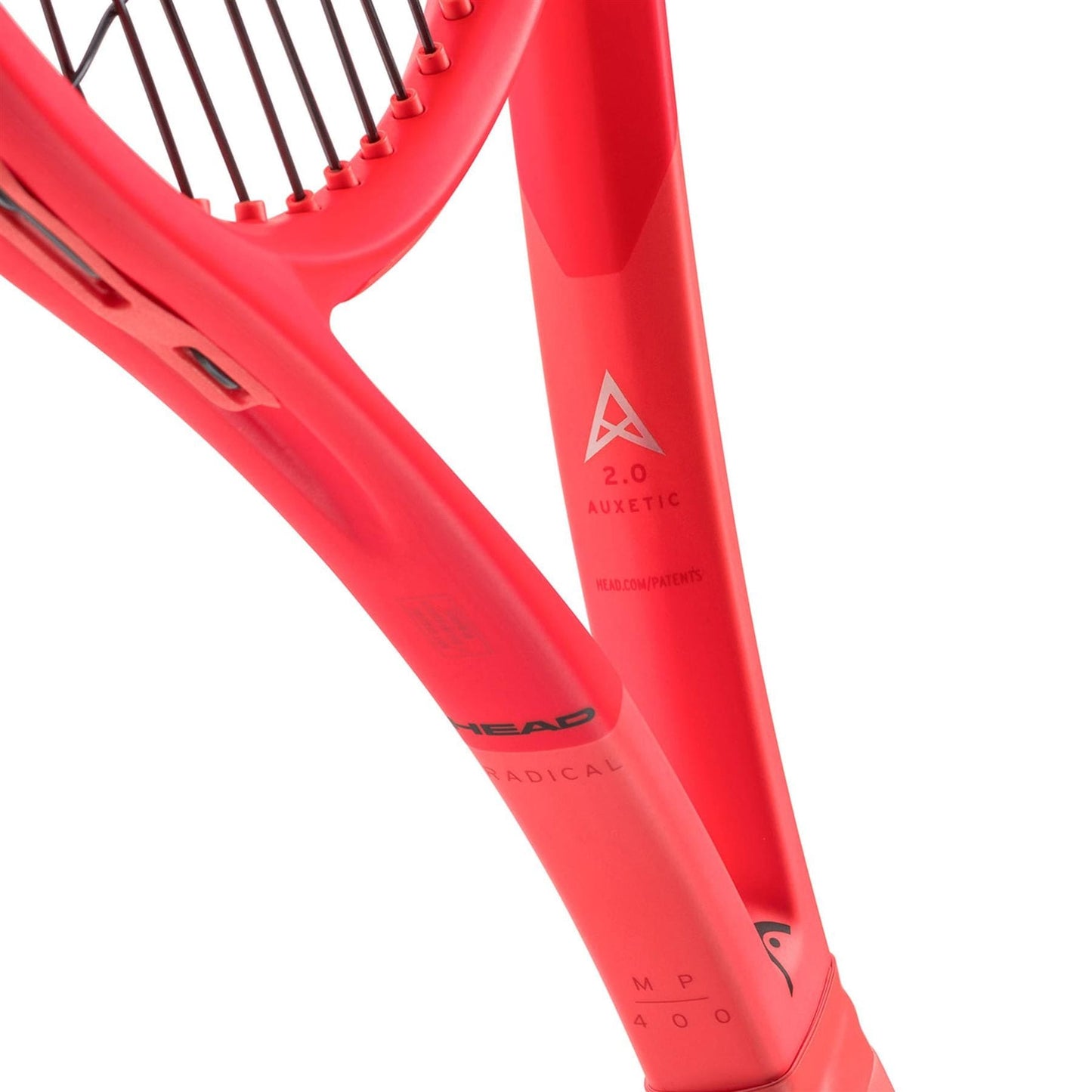 Close-up of an orange HEAD Radical MP 2025 Tennis Racket frame, featuring intricate details like "2.0 AUXETIC" and "MP 400" on the shaft, with the brand name partially visible, highlighting its remarkable all-court performance.