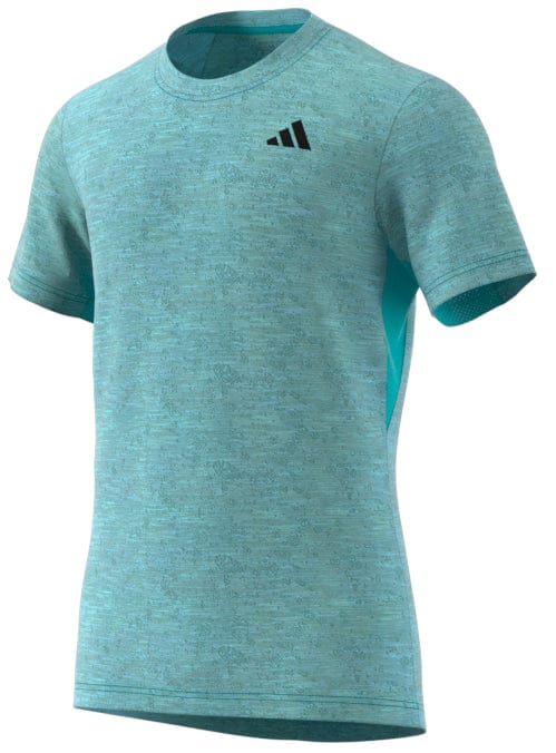 Blue short-sleeve athletic shirt with a subtle pattern and a small logo on the upper left chest. This adidas Men's Freelift tennis T-shirt is designed for comfort and performance, featuring a round neckline and AEROREADY technology to keep you cool and dry.