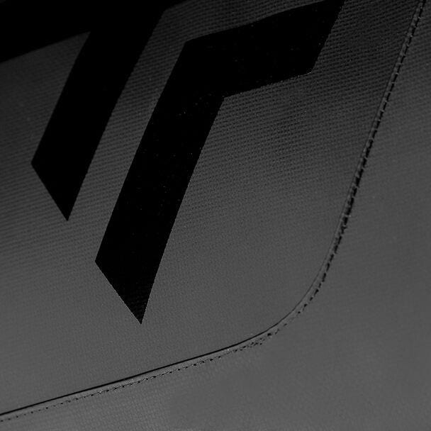 A close-up of a textured surface showcases two prominent, black, angled stripes against a dark gray backdrop. This minimalist design echoes the sleek style found on the Tecnifibre Tour Endurance 2024 12 Racket Tennis Bag - Ultra Black, emphasizing the detailed stitching along the fabric's edges.