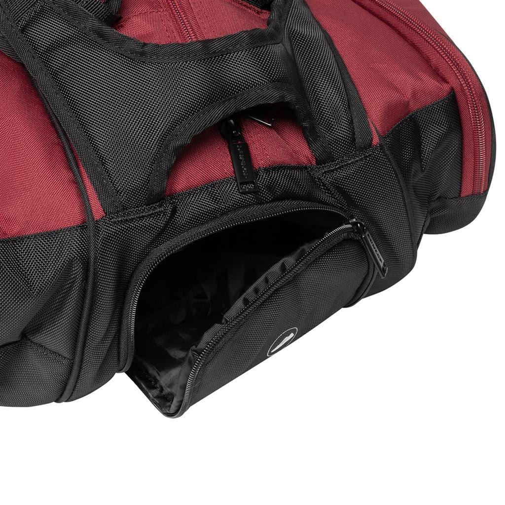 The Dunlop CX Performance 12 Tennis Racket Bag in black and red is shown in a close-up shot with a partially open black zippered pocket. The bag's material displays a textured pattern, and the handle can be seen at the top. This sleek bag from Dunlop includes ergonomic padded shoulder straps for comfort while on the move.