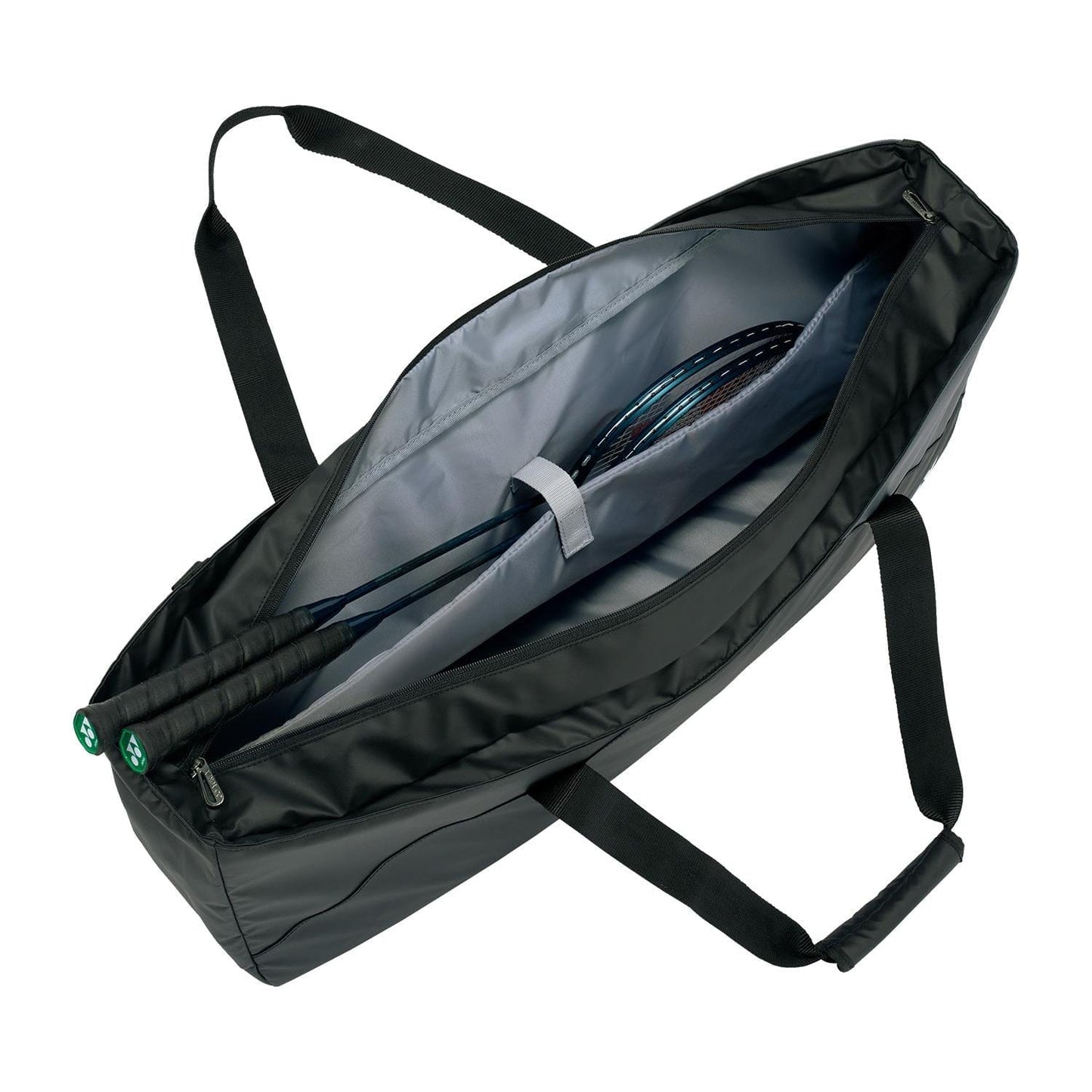 The Yonex 52531EX Club Tournament Tennis Bag in grayish blue has multiple compartments, a shoe compartment, and contains a racket. It features two handles, an adjustable shoulder strap, is partially unzipped to show the racket inside, and has a gray interior lining.