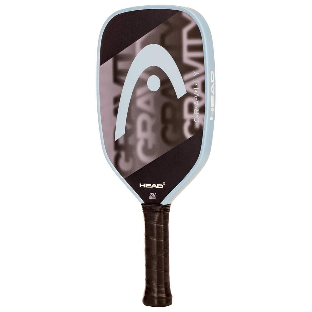 The HEAD Gravity Team EX 2025 Pickleball Paddle in Black/Blue features a black face, light blue edge, large HEAD logo, black grip handle, and "GRAVITY" text. Designed for control and spin potential. Brand: HEAD.