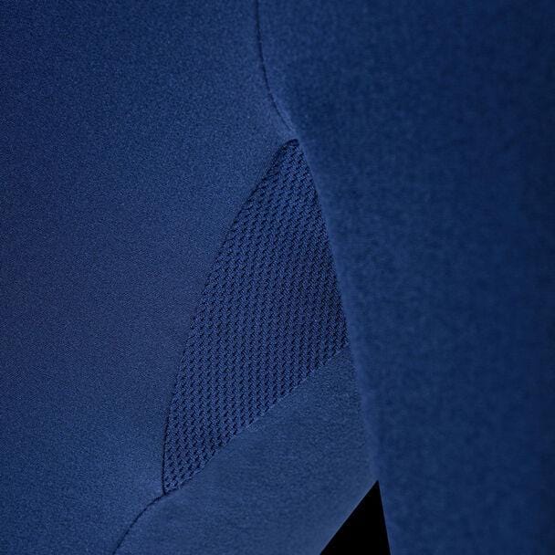 A close-up shot of the Tecnifibre Mens Team Tennis Short - Marine showcases its blue fabric, featuring a textured mesh panel designed for optimum ventilation. The image emphasizes the smooth and detailed surface of this polyester blend material by Tecnifibre.