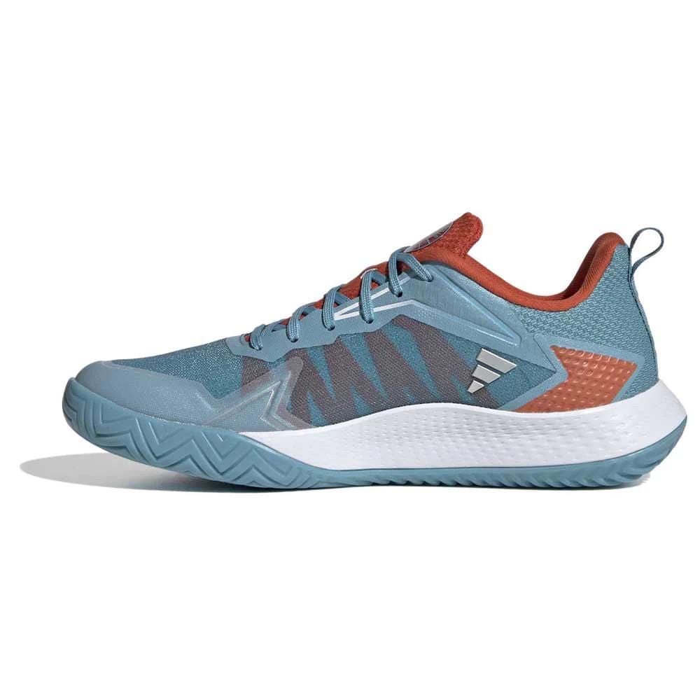 The adidas Defiant Speed Women's Tennis Shoes in blue combine a modern and sporty look, making them the perfect choice for women looking for stylish athletic footwear. Featuring a lightweight mesh upper, these shoes are designed with a textured grip pattern on the white sole and include a convenient pull tab on the heel for easy wear. Their geometric design in blue hues reflects contemporary athletic fashion.
