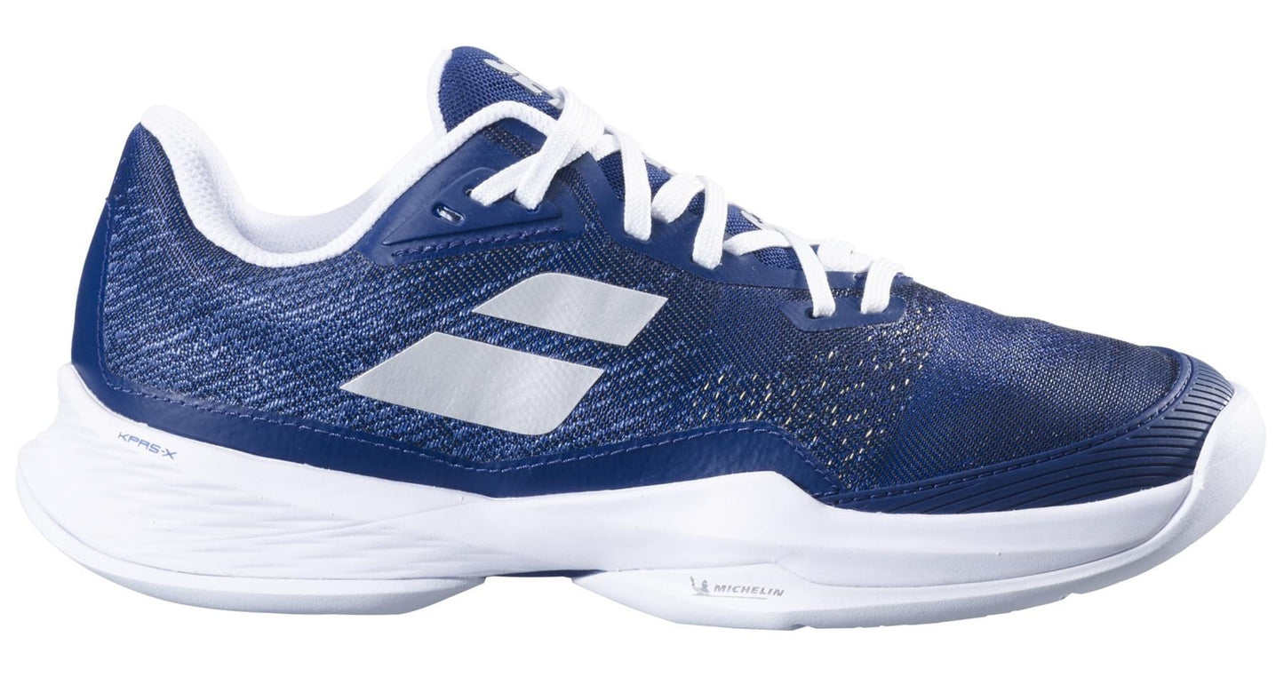 The Babolat Jet Mach 3 All Court 2025 Women's Tennis Shoes in dark blue feature a mesh upper, white laces, and Matryx technology. They have a Michelin sole with a textured design and two silver stripes, ideal for sports enthusiasts.