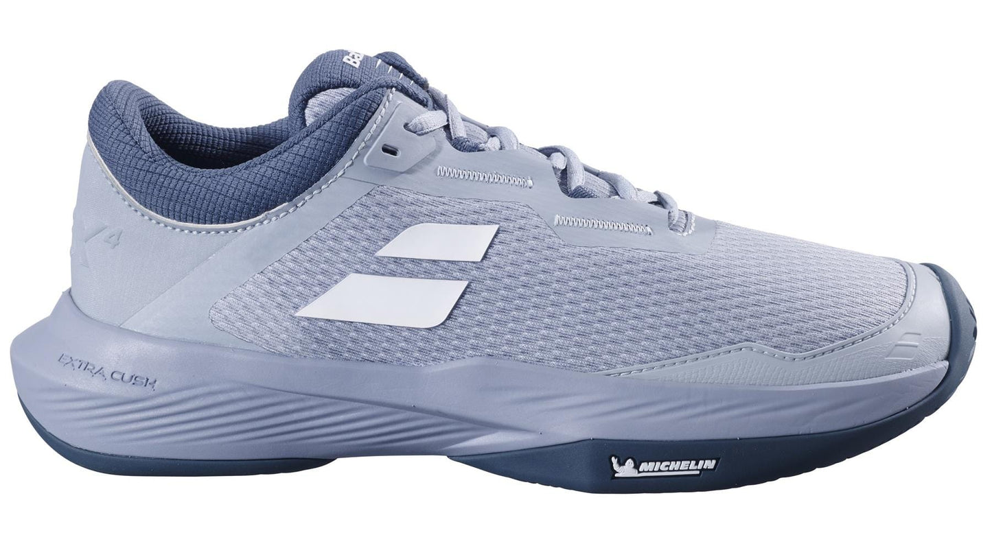 The Babolat SFX 4 All Court 2025 Men's Tennis Shoes in Grey/White feature a mesh upper, dark gray interior and sole, white logo accents, a Michelin rubber outsole, and "EXTRA CUSH." It's a lace-up design perfect for all-court performance.