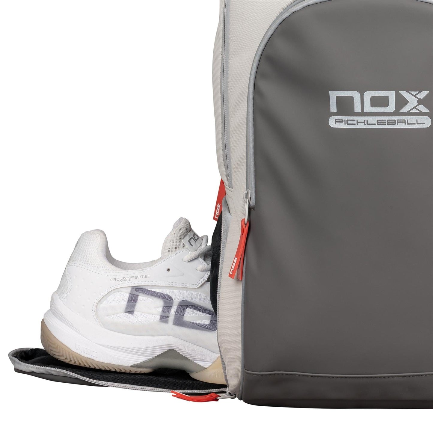 A close-up of the NOX Pro Pickleball Backpack - Cream by NOX shows a partially unzipped side compartment with a white "NOX" athletic shoe inside and ergonomic padded straps for comfort.