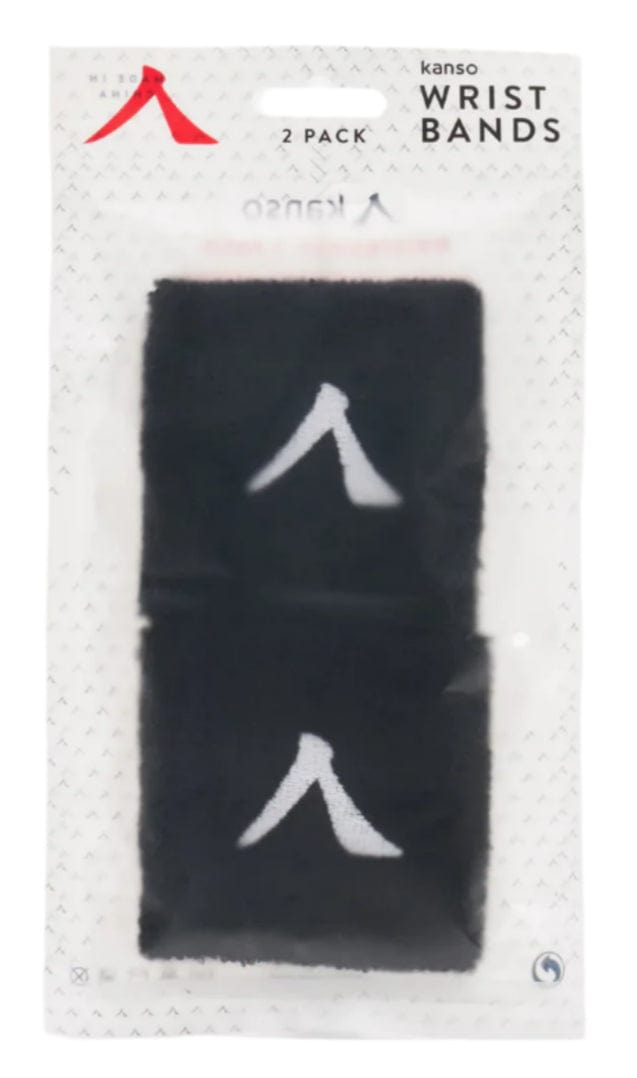 A package of two black Kanso 7cm Wristbands features a simple white logo. The transparent packaging displays "Kanso 7cm Wristband - 2 Pack - Black" on top, with absorbent fabric ensuring comfort for daily use.