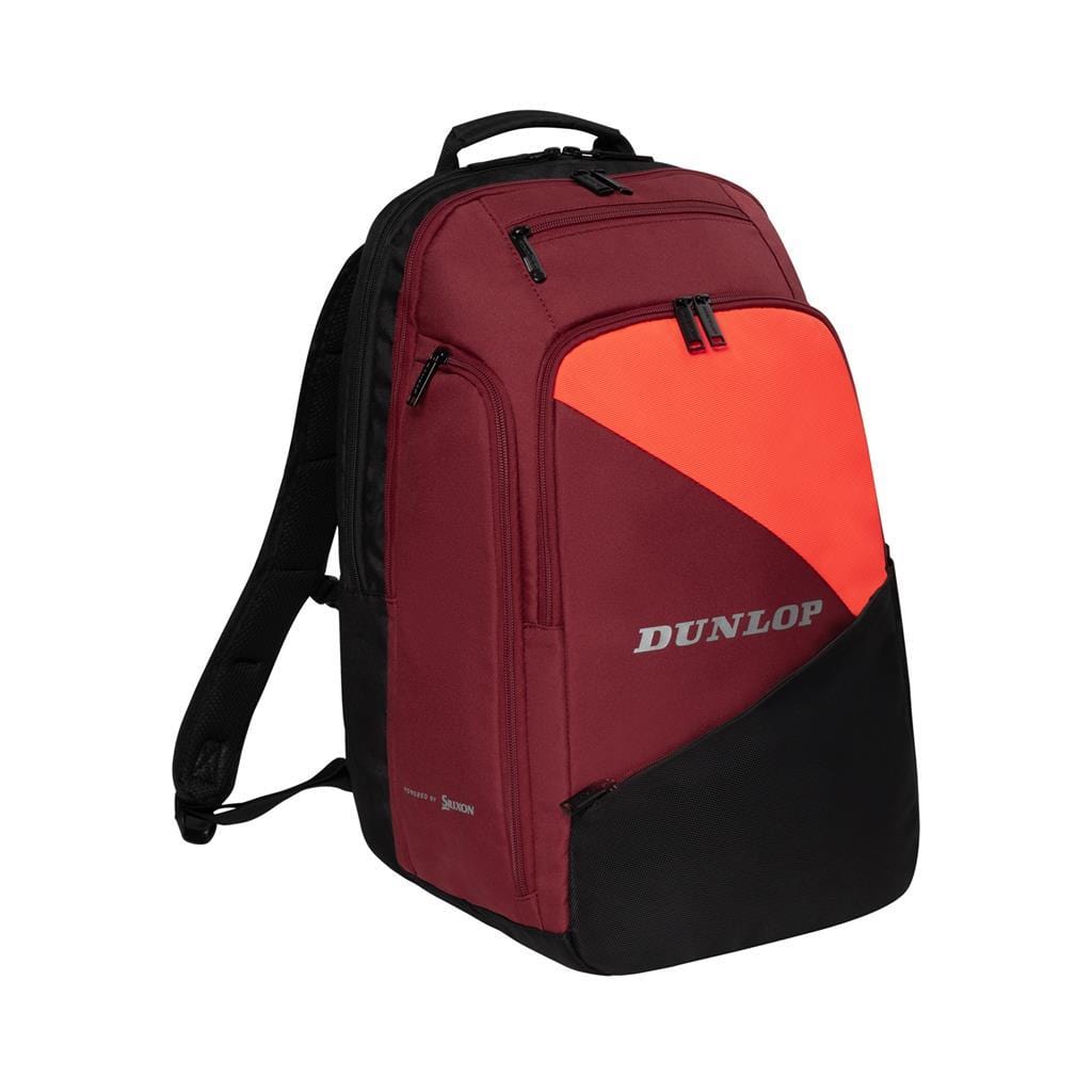 The Dunlop CX Performance Tennis Backpack in black and red boasts several zippered compartments for rackets. It features a vibrant red accent on the front with the white Dunlop logo, embodying its signature CX Performance style. The backpack is designed with adjustable shoulder straps and a practical top handle for ease of carrying.