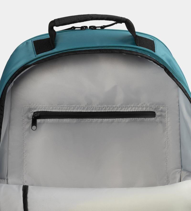 Interior view of the Dunlop SX Club Tennis Backpack reveals a light gray lining, inner back zipper pocket, padded straps, and black handle. The teal exterior is ideal for your tennis gear.