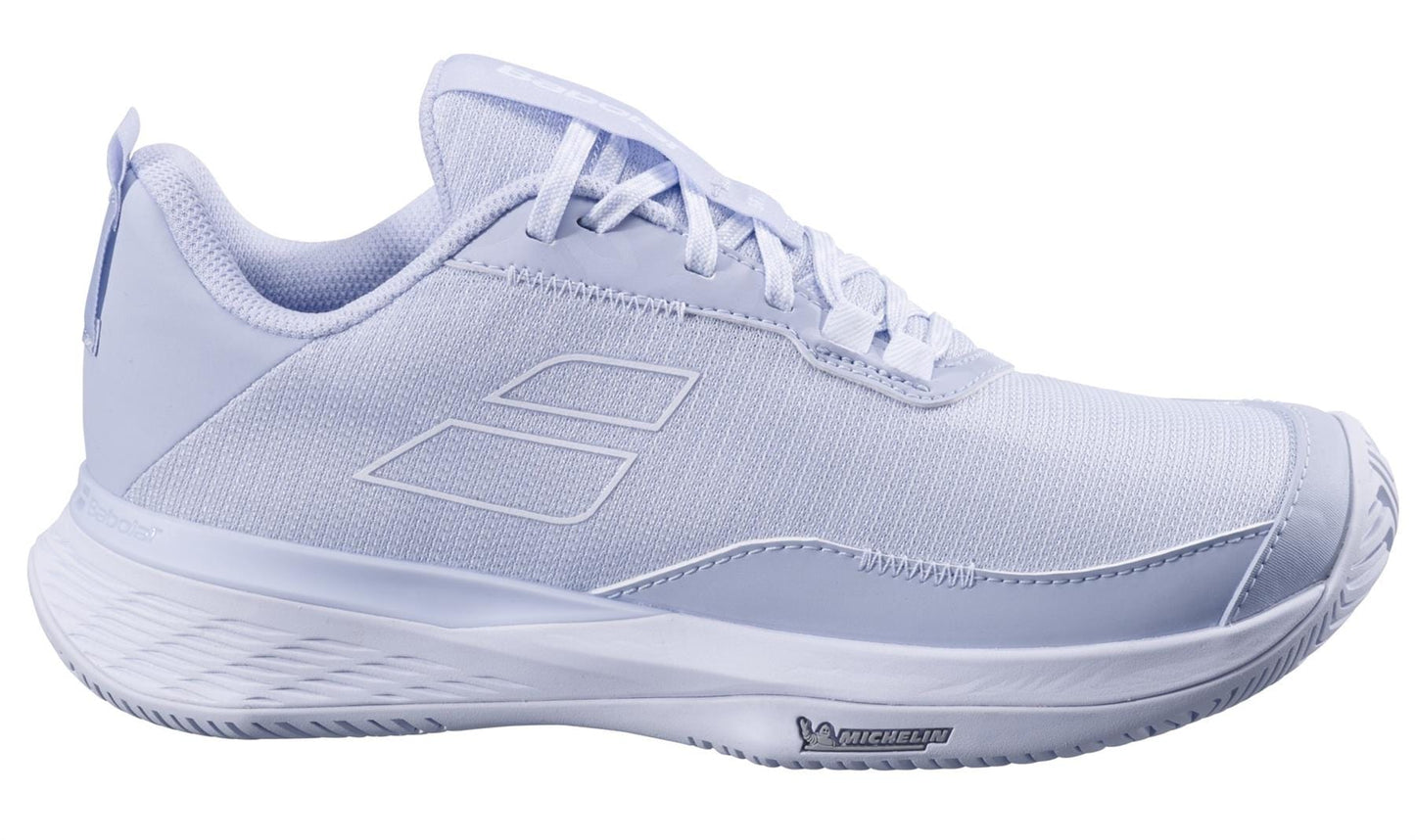 The Babolat SFX EVO All Court 2025 Women's Tennis Shoes, in Xenon Blue and White, feature a textured mesh upper, cushioned sole, and Michelin Original rubber logo. They offer a sleek modern design with subtle branding.