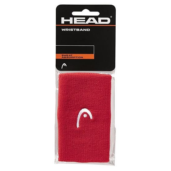 This HEAD 5" Tennis Wristband in red is packaged in a clear plastic bag with a black and orange label. The label prominently features the "HEAD" logo alongside the word "WRISTBAND," emphasizing its superior sweat absorption capabilities.