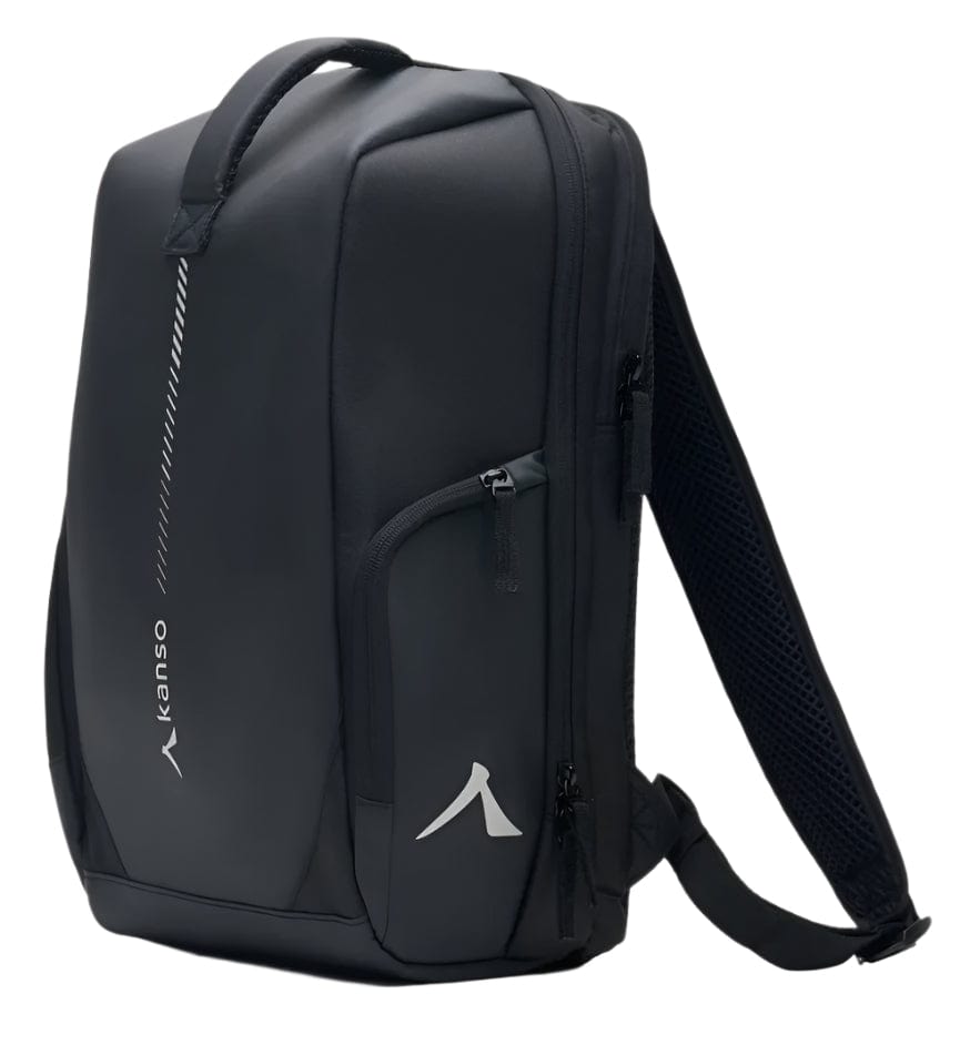 The Kanso Intuko Tennis 23L Backpack - Black is a sleek, minimalist backpack with a durable handle, two main zippers, and a small front pocket. It features a separate compartment and the brand logo resembling an arrow alongside "kanso," making it the perfect everyday companion.