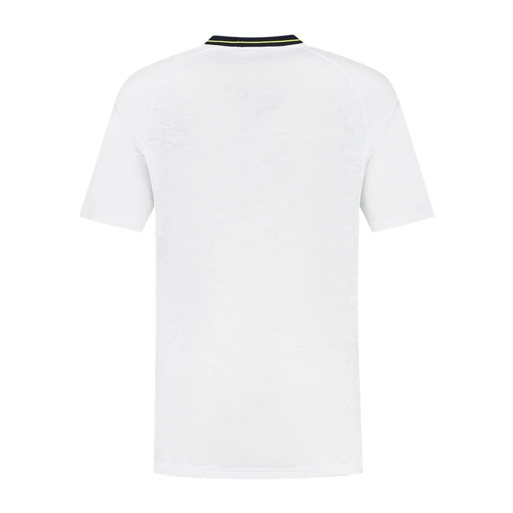 The image showcases the back view of the K-Swiss Hypercourt Melange 2 Men's Tennis T-Shirt in white, featuring short sleeves and made from breathable polyester. A thin black stripe adorns the collar, elevating its minimalist yet high-performance design characteristic of K-Swiss's Hypercourt style, without any visible logos or patterns.