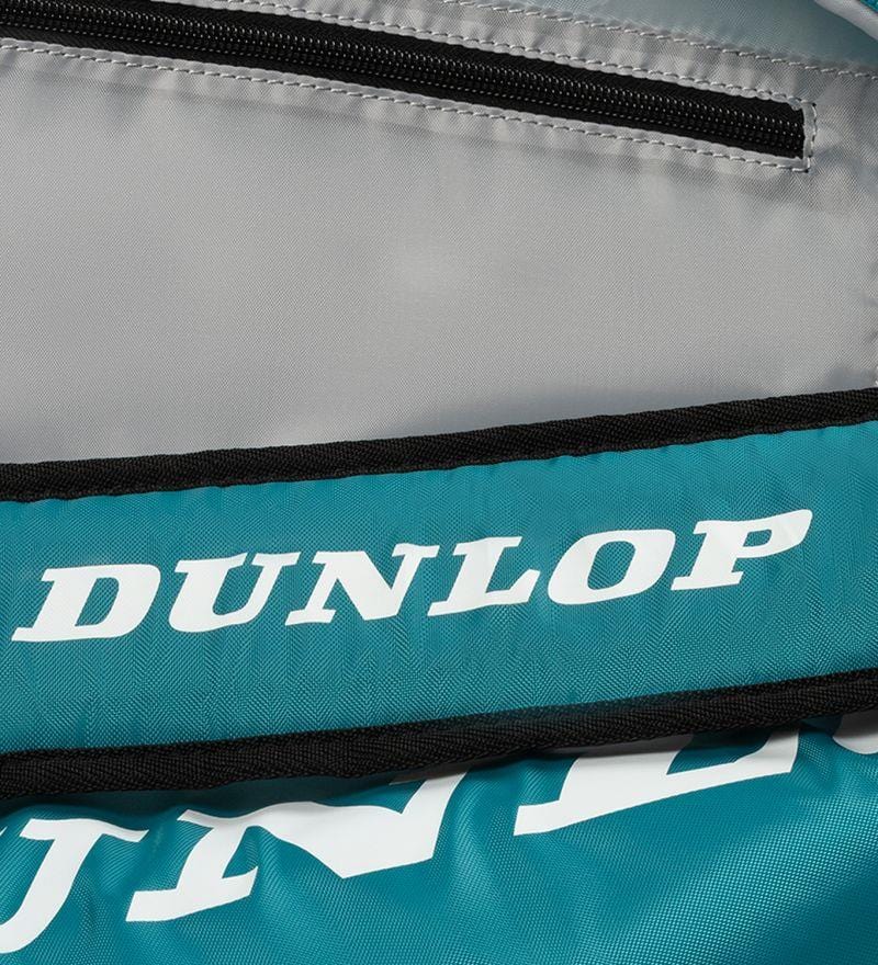 Close-up of a Dunlop SX Club 10 Racket Tennis Bag in teal, black, and yellow. The white Dunlop logo contrasts on the teal area, emphasizing its importance as essential tennis equipment. A partially visible black zipper is at the top.