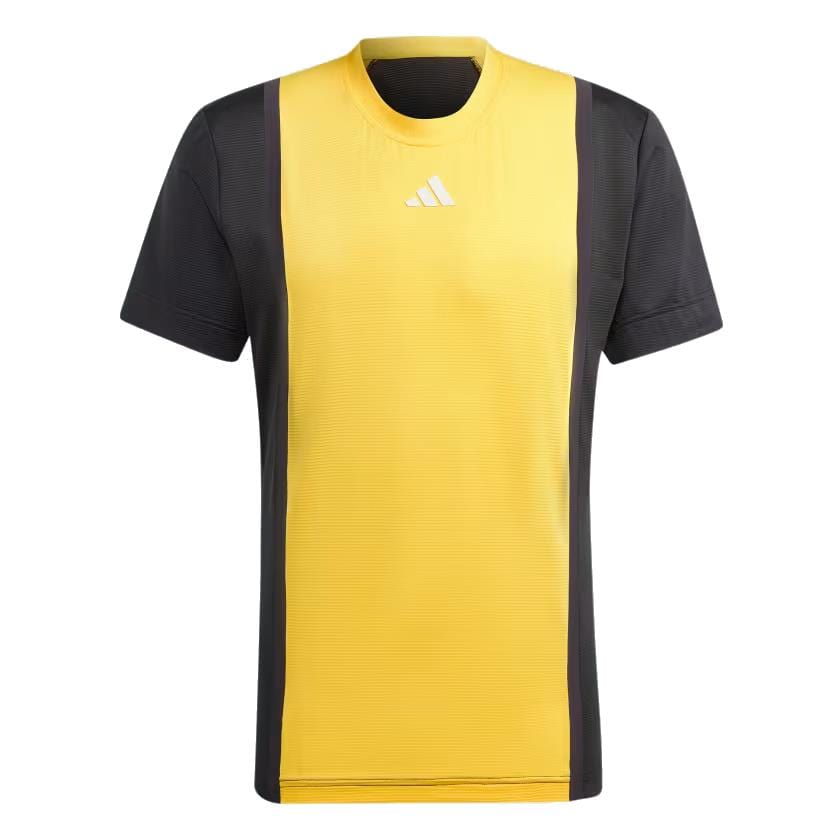 The adidas Mens Paris Pro 3D Rib Tennis T-Shirt in Spark and Black boasts a yellow front panel paired with black side panels. It's designed with FreeLift sleeves for ease of movement, and adorned with a small white Adidas logo near the neckline, adding to its minimalist style. The round neck along with HEAT.RDY technology enhances comfort and fashion appeal.
