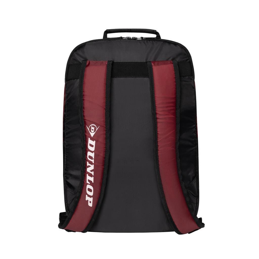 The Dunlop CX Club Tennis Backpack in black and red boasts padded shoulder straps with "Dunlop" printed on the left side. Its sleek design also includes a top handle, ideal for effortlessly carrying your tennis or badminton essentials.