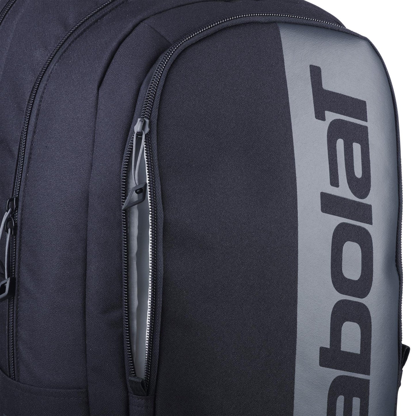 Close-up of the Babolat Court Hero Tennis Backpack in black, showcasing a spacious design and a large zipper pocket. "Babolat" is printed vertically on the gray section, enhancing its modern appeal.