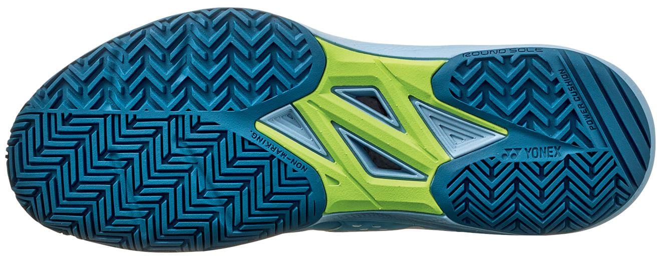 The Yonex Power Cushion Sonicage WIDE 2025 in Grayish Blue showcases a geometric tread pattern on its "NON MARKING" sole. This lightweight tennis shoe offers superior grip and comfort with its blue and green Power Cushion sole featuring a sleek zigzag design.