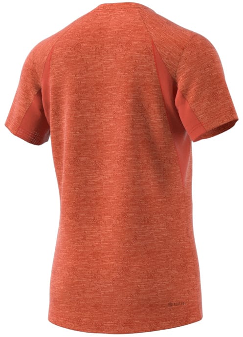 Rear perspective of a red short-sleeve athletic tee featuring a heathered texture and understated panel detailing. Constructed with cooling fabric, this ADIDAS Men's Freelift Tennis T-Shirt by adidas is lightweight and tailored for comfort and performance.
