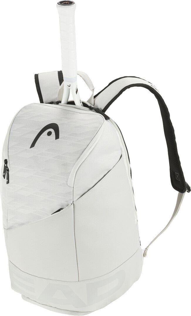 The HEAD Pro X 28L Tennis Backpack - YUBK by HEAD is a stylish choice in white, featuring a black logo and adjustable shoulder straps. It includes a padded racquet compartment with an accessible handle and side pockets for gear, as well as a ventilated shoe compartment to keep everything fresh.