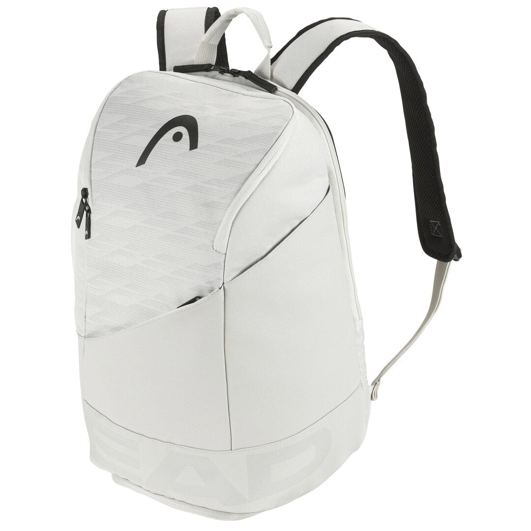 The sleek HEAD Pro X 28L Tennis Backpack - YUBK, in a sophisticated white with black highlights and a gentle geometric design, offers a spacious main compartment, a ventilated section for shoes, two zippered side pockets, and comfortable padded shoulder straps. The brand's logo is prominently displayed on the upper front.