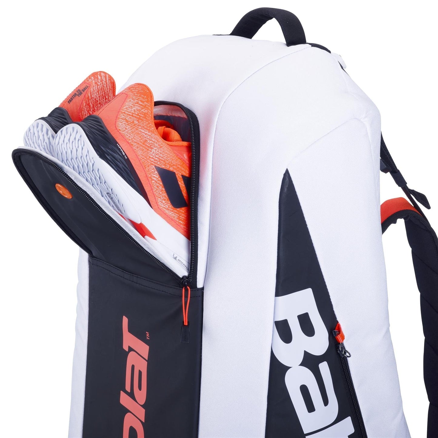A versatile Babolat RH6 Pure Strike 4th Gen 6 Racket Tennis Bag, in a striking black, white, and red color scheme, showcases an innovative design with a side compartment partially unzipped to reveal orange and white sneakers. The Babolat logo is prominently visible on this stylish bag.