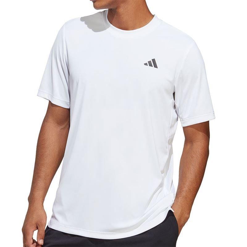 A person wearing an adidas Men's Club Tennis T-Shirt in white, featuring a subtle logo on the chest, stands against a simple background, not fully visible in the frame.