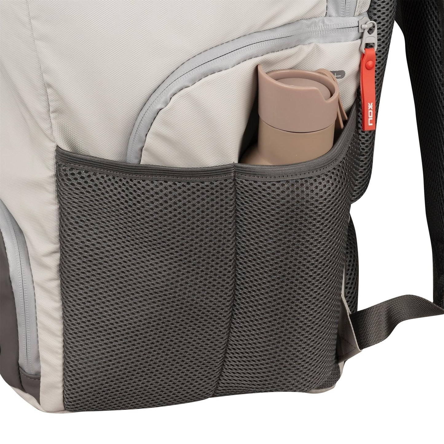 A close-up of the NOX Supra Pickleball Backpack - Cream shows its dark gray mesh side pocket holding a beige reusable water bottle. The light gray bag by NOX features ergonomic padded straps and a zipper with a red pull tab.