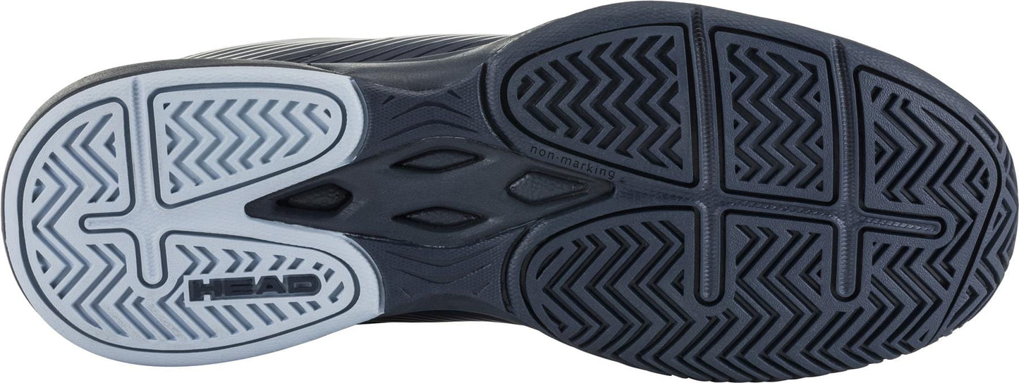 The image showcases the sole of the HEAD Revolt Court Women's Tennis Shoes, displaying a multi-patterned tread design. The lightweight comfort sole is primarily black with a gray section, featuring the "HEAD" brand name printed on it. The wavy, zigzag, and grid patterns provide traction, making these blueberry and light blue shoes ideal for agile performance.