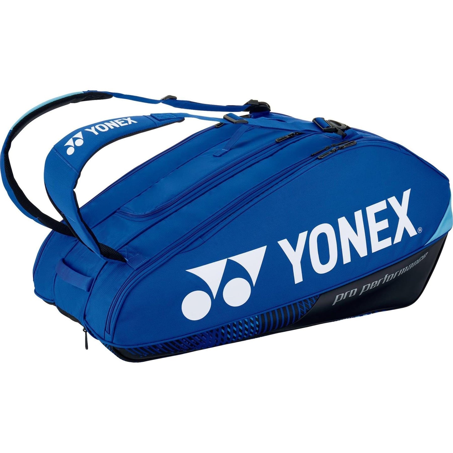 The Yonex 92429EX 9 Racket Pro Tennis Bag, in a stylish cobalt blue color, prominently displays the "YONEX" brand name in white. It features Thermo Guard lining and includes two adjustable straps along with several zippered compartments, providing an ideal solution for securely transporting your tennis gear.
