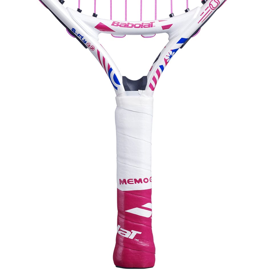 Close-up of a pink and white Babolat B-Fly 17 Junior Tennis Racket featuring "MEMO G" branding on the handle. This beginner tennis racket showcases visible strings and a grip wrapped in white tape, ideal for young athletes embarking on their tennis journey.