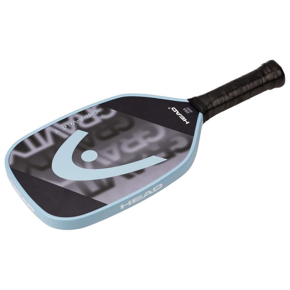 The HEAD Gravity Team EX 2025 Pickleball Paddle in Black/Blue features a textured grip for enhanced control, excellent spin potential, and the HEAD logo on the face, shown on a white background.