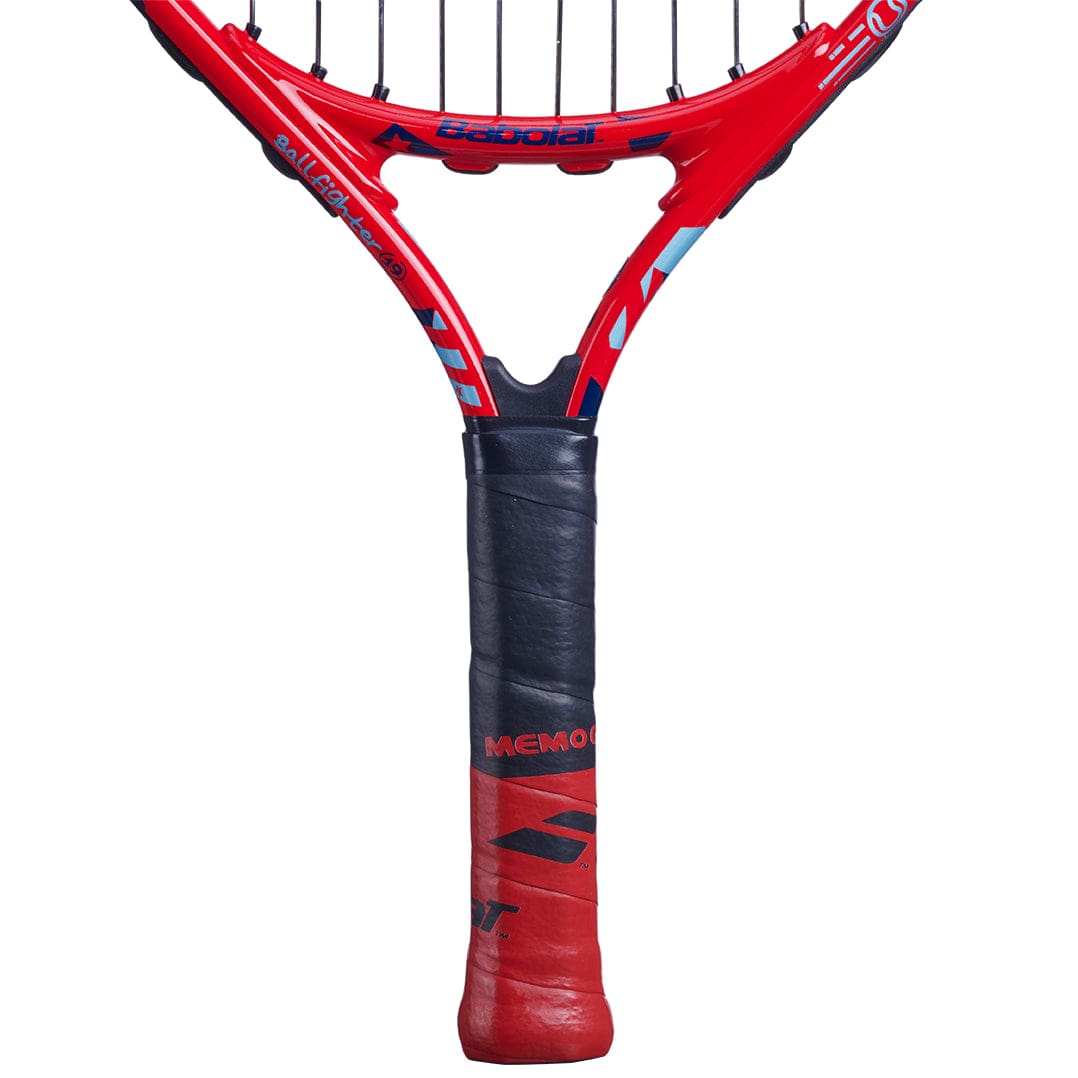 Close-up of a Babolat BallFighter 19 Junior Tennis Racket, showcasing the brand markings on the throat. It features tightly strung strings and a black teaching grip, with striking blue and red accents on the frame.