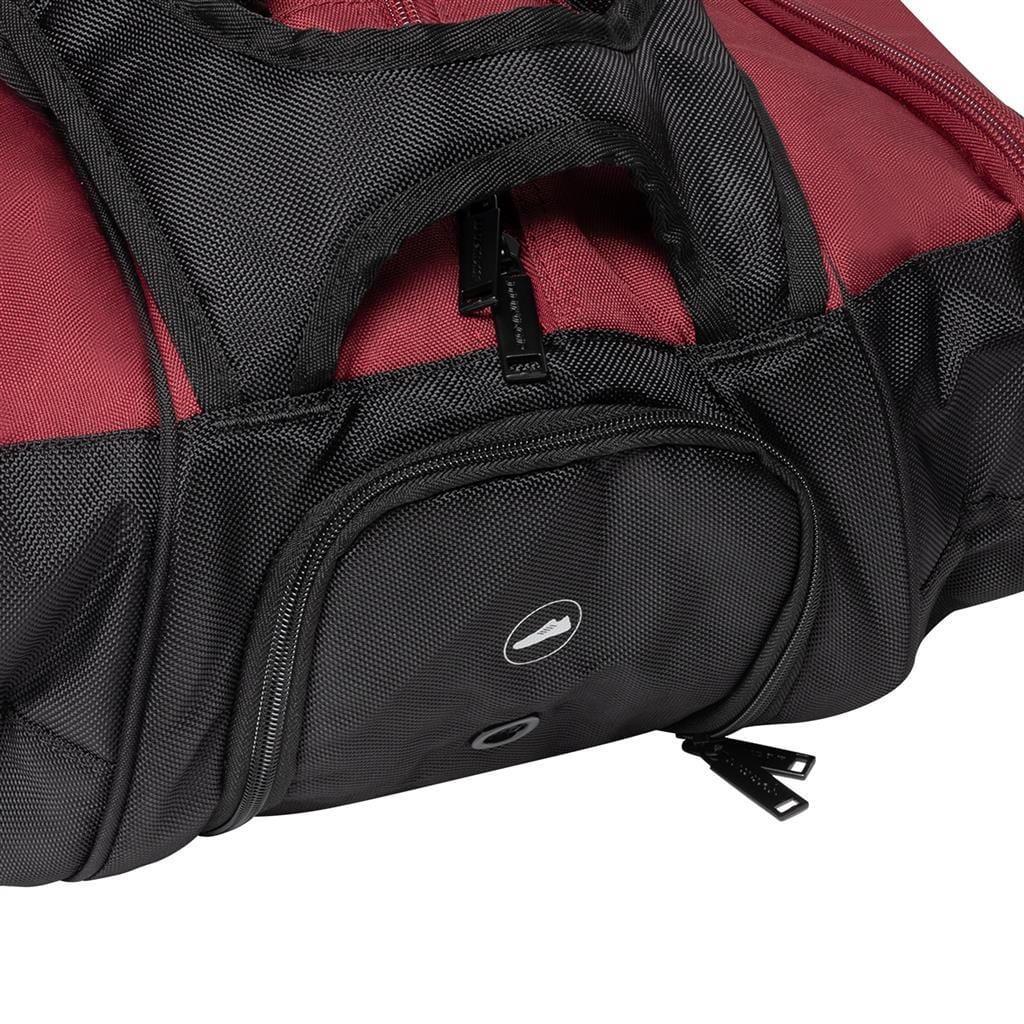 Introducing the Dunlop CX Performance 12 Tennis Racket Bag in black and red. This bag features a round logo and a textured fabric surface, enhanced with multiple visible zippers for optimal accessibility. Designed with ergonomic padded shoulder straps and handles, it ensures easy portability. Additionally, it includes a ventilated shoe compartment for extra convenience.