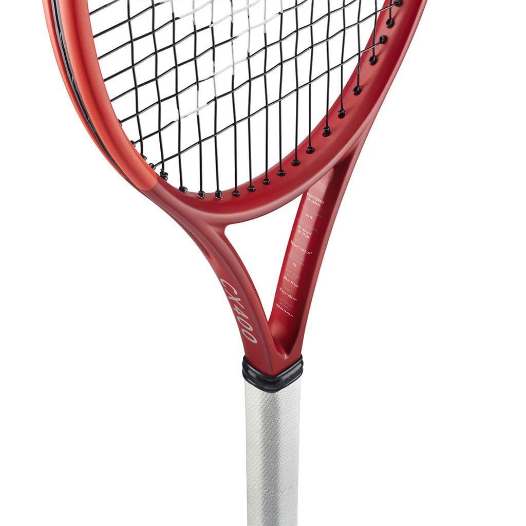 Close-up of the Dunlop CX 400 2024 Tennis Racket in red, highlighting its Powergrid Stringtech with black strings and a white grip. The racket is tilted to showcase its frame and string pattern, with the Dunlop logo visible on the side. The white background emphasizes the racket's details.